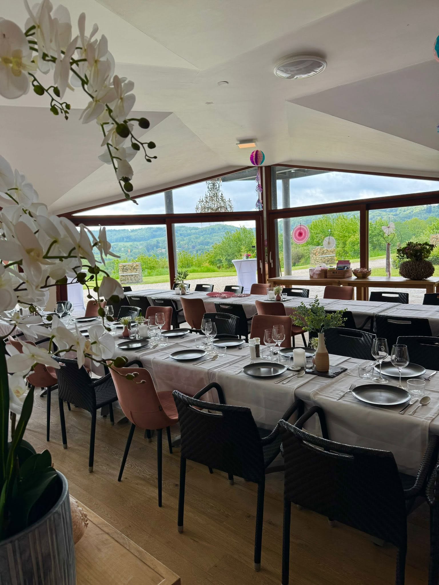 The event room at Giraffe Lodge with a long laid table and a view over the hills
