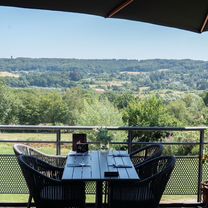 Laid table on the terrace of Giraffe Lodge with views over the hills